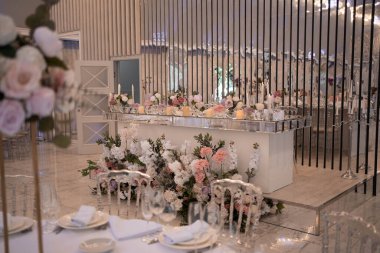 Table setting at a luxury wedding reception. Beautiful flowers on the table. Wedding day.