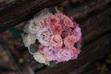 Wedding bouquet composed of roses, ozothamnus, freesia and eucalyptus. Pink bridal bouquet.