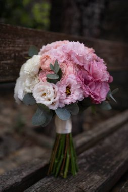 Wedding bouquet composed of roses, ozothamnus, freesia and eucalyptus. Pink bridal bouquet.