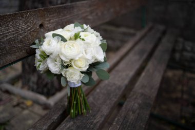 Wedding bouquet of white flowers - ranunculus, freesia, lisianthus.. Bride and groom. Wedding Dress
