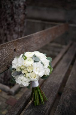 Wedding bouquet of white flowers - ranunculus, freesia, lisianthus.. Bride and groom. Wedding Dress