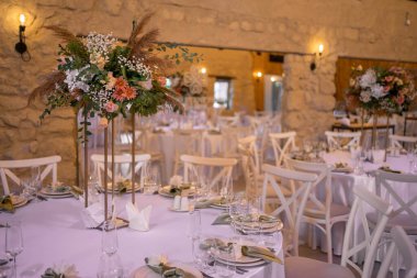 Autumn wedding table setting with flower centerpieces and candles. Wedding day. Autumn wedding decorations.