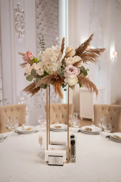 Boho wedding decor. Wedding centerpieces arrangements with dried flowers floristry and candles, boho style. Wedding day.