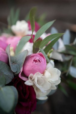 Wedding bouquet composed of roses, ozothamnus, freesia and eucalyptus. Pink bridal bouquet.