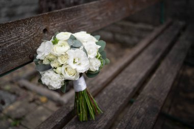 Wedding bouquet of white flowers - ranunculus, freesia, lisianthus.. Bride and groom. Wedding Dress