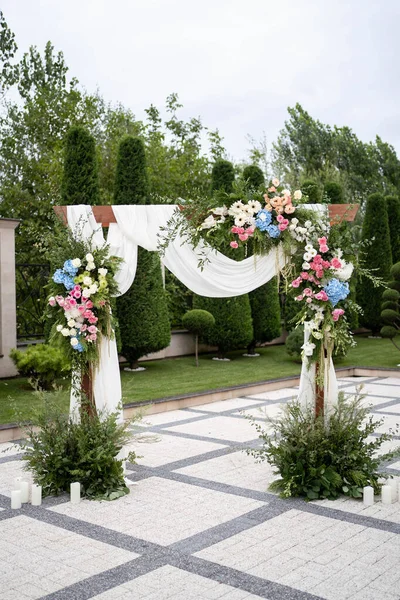 Beautiful Wedding ceremony event. Outdoor wedding arch. Green and white wedding decorations.