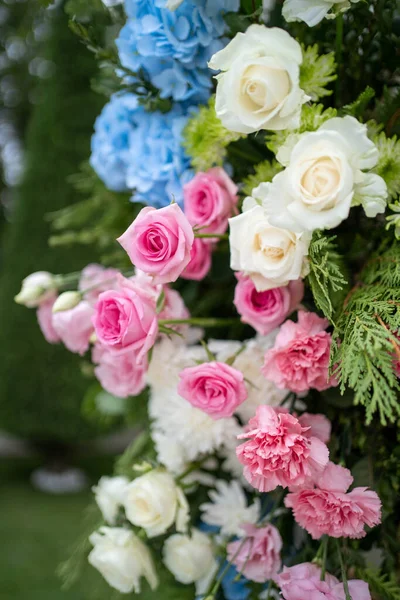 Beautiful Wedding ceremony event. Outdoor wedding arch. Colourful wedding decorations.