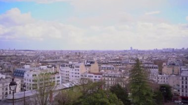 Paris 'in merkezinde eski binalar, çiçek açan ağaçlarla dolu bir sokak. Ağır çekim. Panoramik görünüm.