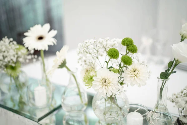 Wedding decoration table in the hall, floral arrangement. In the style vintage. Decorated dining table with flowers for guests and newlyweds, in white color. Beautiful table setting.