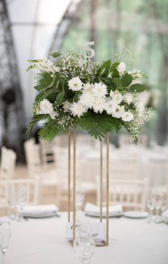 Luxury wedding table setting with flower centerpieces and candles. Wedding day.