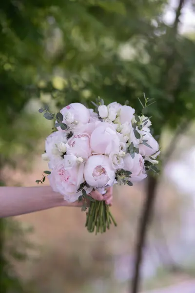 Beauty wedding bouquet made from light pink peonies. Wedding day. Wedding floristic