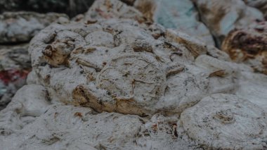 Close up of a textured, weathered stone surface with intricate carvings. clipart