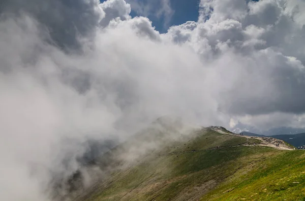 stock image A people mountain trail walks into a cloud. Relaxation in the high mountains.