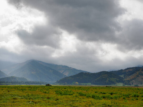 View of the Hoczanskie Mountains. In the foreground, a plowed farmland. Zilina Region. Liptowski Tarnowiec. Slovakia.