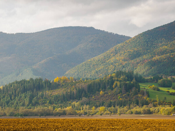 View of the Hoczanskie Mountains. In the foreground, a plowed farmland. Zilina Region. Liptowski Tarnowiec. Slovakia.