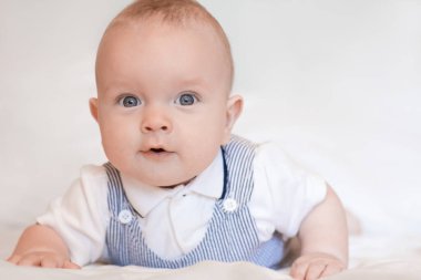 Yatakta şık bir erkek bebeğin portresi. Yüksek kalite fotoğraf