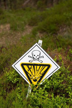 Close up of warning sign on meadow