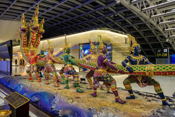 Bangkok, Thailand - November 27, 2022: Churning of the Ocean of Milk statue at Suvarnabhumi Airport departure lounge in Bangkok, Thailand. Churning of the ocean of milk, in Hinduism, one of the central events in the ever-continuing struggle between t