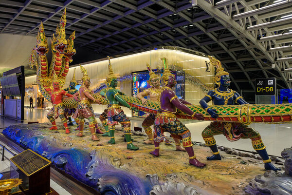Bangkok, Thailand - November 27, 2022: Churning of the Ocean of Milk statue at Suvarnabhumi Airport departure lounge in Bangkok, Thailand. Churning of the ocean of milk, in Hinduism, one of the central events in the ever-continuing struggle between t