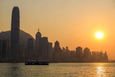 Hong Kong - February 28, 2023: View of the Hong Kong skyline from the Tsim Sha Tsui district in Kowloon with Victoria Harbour.