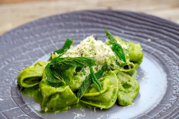 stock image Hand made pasta. Foraged wild nettle and oxtail tortellini in nettle sauce with parmesan cheese.