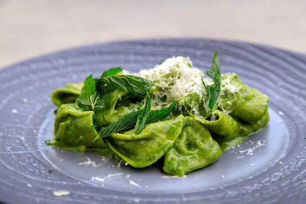 stock image Hand made pasta. Foraged wild nettle and oxtail tortellini in nettle sauce with parmesan cheese.