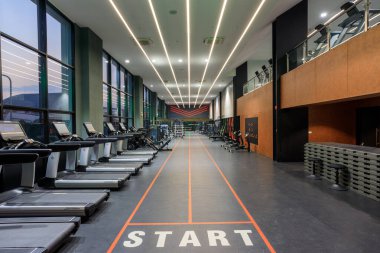 Bang Saen, Thailand - March 6, 2024: Interior view of Bang Saen Body Works fitness center and health club with high end fitness equipment. clipart