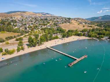 A drone aerial point of view landscape of Kalamalka Lake beach located in the Okanagan Valley near Vernon in the city of Coldstream, British Columbia, Canada.  clipart