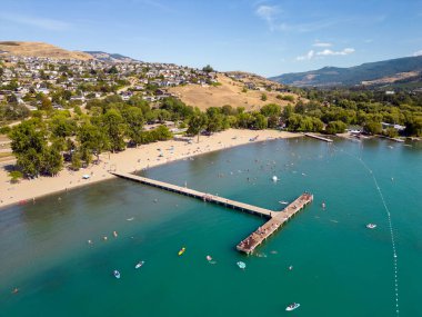 A drone aerial point of view landscape of Kalamalka Lake beach located in the Okanagan Valley near Vernon in the city of Coldstream, British Columbia, Canada.  clipart