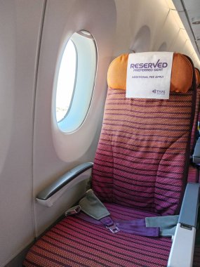 Bangkok, Thailand - October 30, 2024: An emptied passenger seat near window economy class Thai Airways TG657 international Airbus A350-900. Flight destination from Seoul to Bangkok. clipart