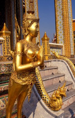 Wat Phra Kaew, commonly known as the Temple of the Emerald Buddha is regarded as the most sacred Buddhist temple in Thailand.  clipart