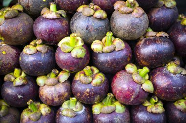 Assortment of fresh ripe organic tropical fruit mangosteen at Ben Thanh Market in Ho Chi Minh City, Vietnam. clipart