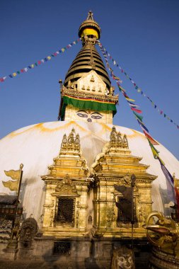 Katmandu, Nepal - 7 Ekim 2012: Swayambhunath Stupa altın kulesiyle mavi gökyüzüne karşı duruyor Katmandu, Nepal 'de zengin tarihini ve manevi önemini gözler önüne seriyor..