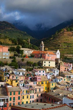Aerial landscape of Vernazza village. Ancient buildings between mountains and the sea. Famous touristic place and travel destination in Italy. Vernazza, Cinque Terre. UNESCO World Heritage Site.