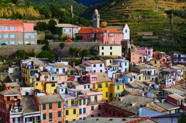 Aerial landscape of ancient buildings in Vernazza. Village between mountains and the Ligurian sea. Famous touristic place and travel destination in Italy. Cinque Terre. UNESCO World Heritage Site.