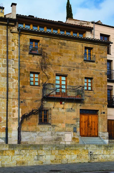 Typical vintage building in the old town of Salamanca. Facade of ancient building with doors, windows and one balcony. Concept of landscape and architecture. Salamanca, Spain.