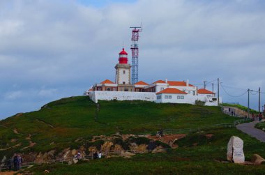 Lighthouse and Atlantic ocean at Cape Roca (Cabo da Roca). Western point of Europe. Tourists enjoying amazing landscape on Cabo da Roca.