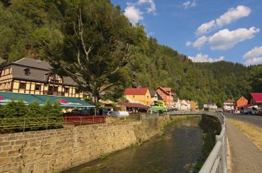 Hrensko, Çek Cumhuriyeti-23 Ağustos 2018: Eski binalar ve Kamenice Nehri ile köy caddesinin manzarası. Bohem İsviçre Ulusal Parkı. Ünlü turistik mekan ve tatil beldesi. 