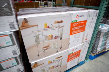 Los Angeles, California, United States - 05-20-2022: A view of several boxes of Trinity kitchen carts with stainless steel top, on display at a local big box grocery store.