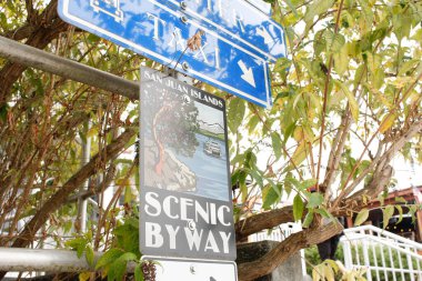 Friday Harbor, Washington, United States - 09-11-2021: A view of a road sign that lets drivers know they are directed towards the San Juan Islands Scenic Byway.