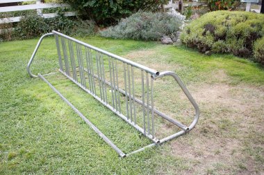 A view of a metal bicycle rack, seen at a local park.