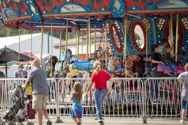 Puyallup, Washington, United States - 09-13-2021: A view of people enjoying the carousel ride at the Washington State Fair.