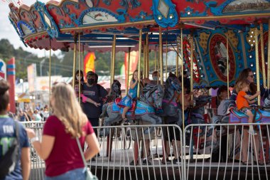 Puyallup, Washington, United States - 09-13-2021: A view of families enjoy the carousel ride at the Washington State Fair.