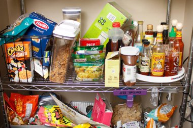 Los Angeles, California, United States - 03-01-2022: A view of a home pantry filled with an assortment of food products.