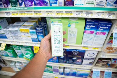 Los Angeles, California, ABD - 05-20-2022: Baush ve Lomb Bio Gerçek Kontak lens çözeltisi paketini tutan bir elin görüntüsü, yerel bir bakkalda sergileniyor.