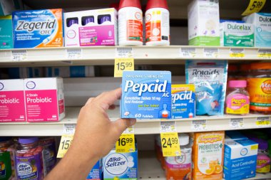 Los Angeles, California, ABD - 05-20-2022: Pepcid AC kutusunu tutan bir elin görüntüsü, yerel bir bakkalda sergileniyor.