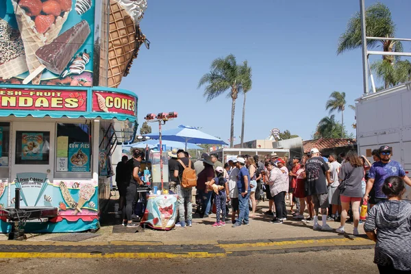 stock image Garden Grove, California, United States - 05-30-2022: A view of a people waiting in line at a food concession stand, seen at the Strawberry Festival.