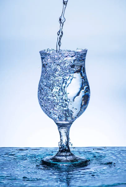 The image of pouring drinking water, into a broken glass, that makes one feel refreshed on blurred white background, Splashing water, Sparkling water, Danger or imminent danger concept