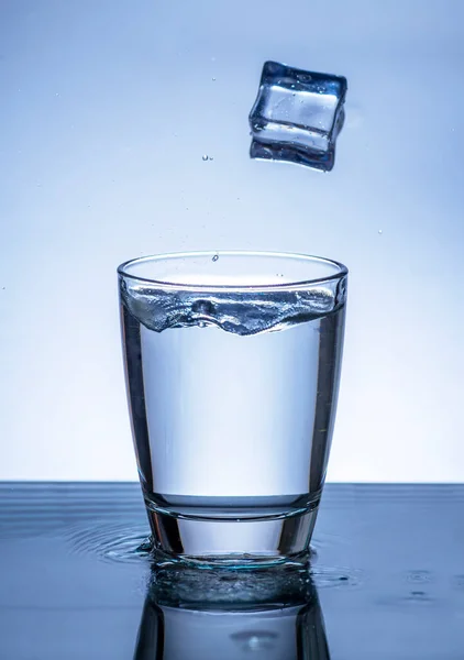 The image of pouring drinking water, into a glass, that makes one feel refreshed on blurred white background, Splashing water, Sparkling water