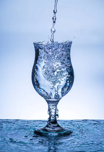The image of pouring drinking water, into a broken glass, that makes one feel refreshed on blurred white background, Splashing water, Sparkling water, Danger or imminent danger concept